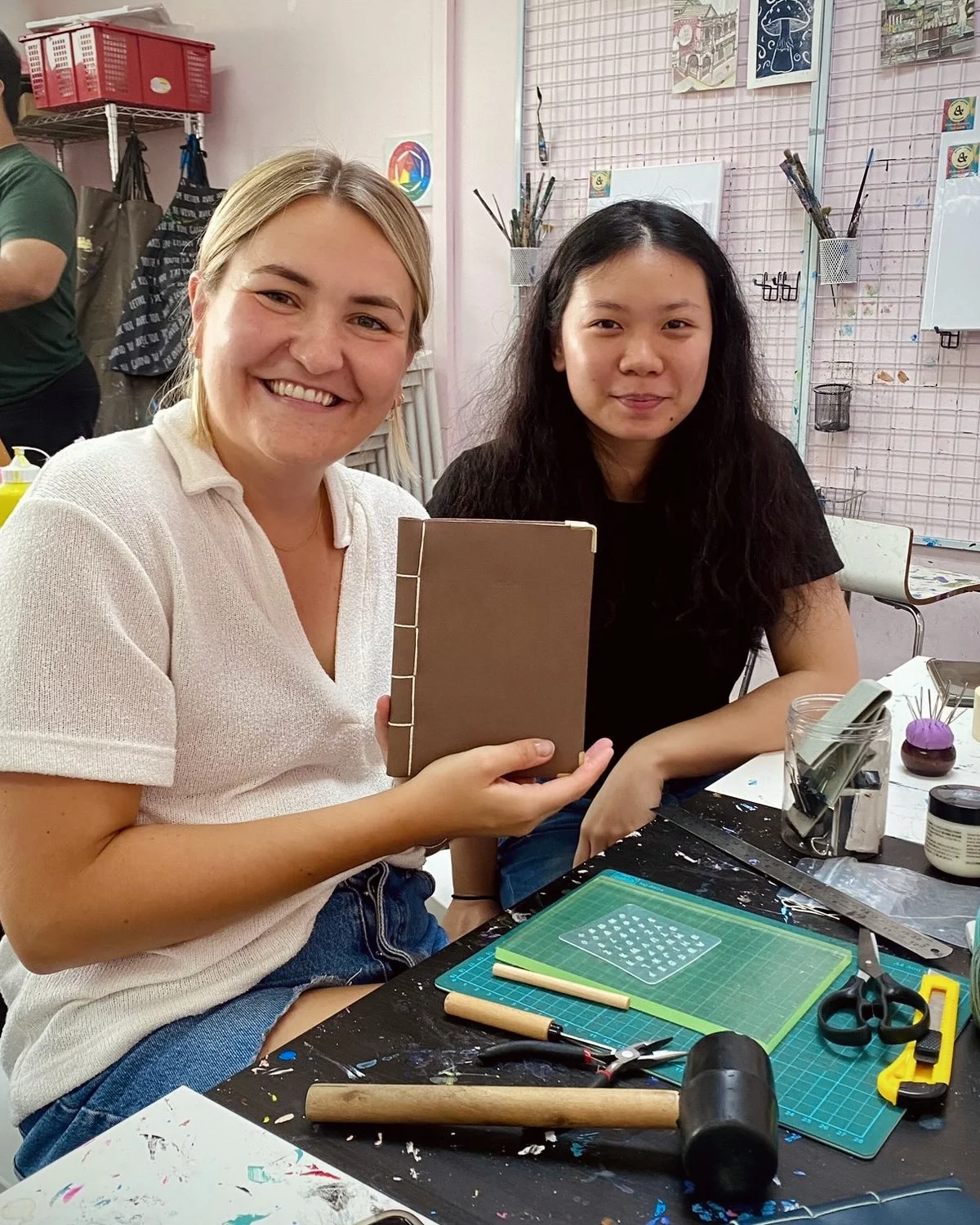 Community artisans collaborating at a leathercraft workshop